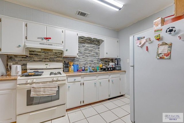 24 Ivy Ln, Brownsville, TX 78521 - kitchen featuring white appliances, under cabinet range hood, tasteful backsplash, light countertops, and crown molding