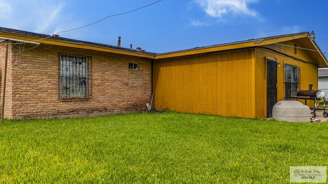 24 Ivy Ln, Brownsville, TX 78521 - view of side of property with a yard and brick siding
