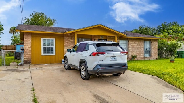 24 Ivy Ln, Brownsville, TX 78521 - ranch-style house with board and batten siding and brick siding