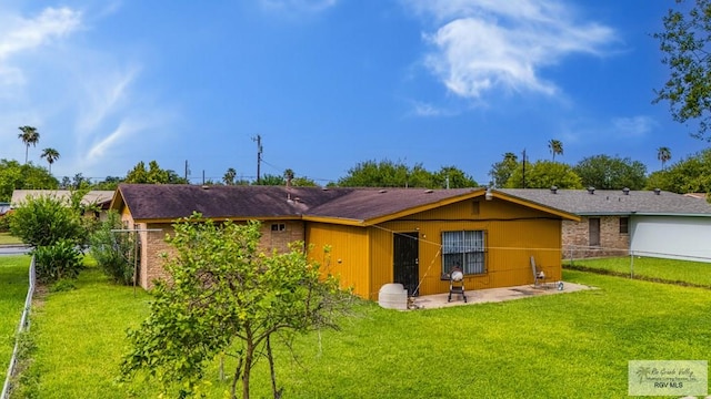 24 Ivy Ln, Brownsville, TX 78521 - back of house featuring brick siding and a patio