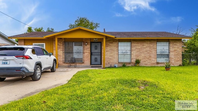 24 Ivy Ln, Brownsville, TX 78521 - ranch-style home featuring a front lawn, brick siding, and roof with shingles