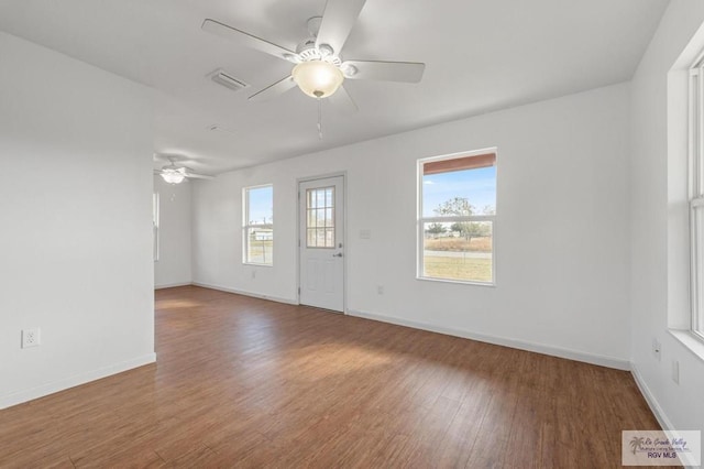 empty room with wood-type flooring and ceiling fan