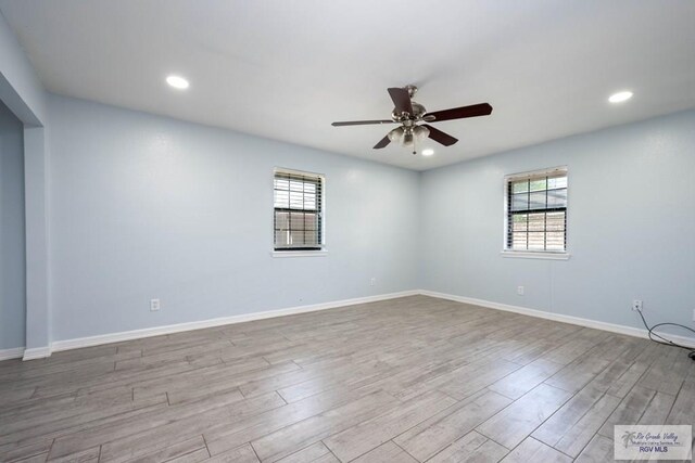 5906 Sunrise Blvd, Harlingen, TX 78552 - empty room with healthy amount of natural light, a ceiling fan, wood finished floors, baseboards, and recessed lighting