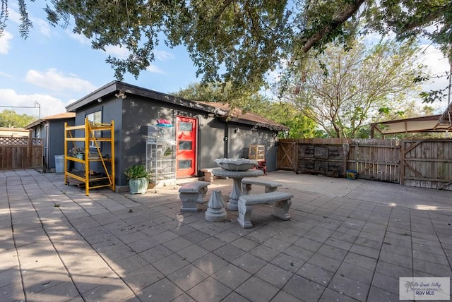 5906 Sunrise Blvd, Harlingen, TX 78552 - fenced backyard featuring a gate and a patio area