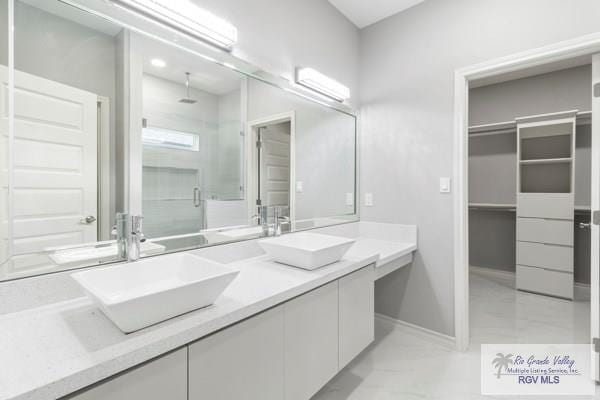 bathroom with a shower with door and vanity