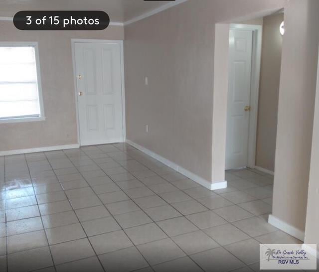 tiled empty room with ornamental molding