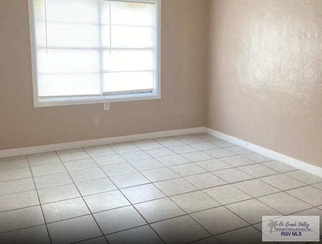 spare room featuring light tile patterned floors