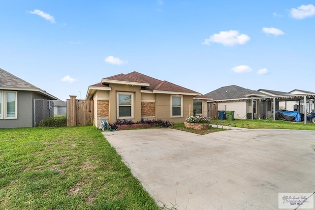 prairie-style house with a front yard, stone siding, fence, and stucco siding