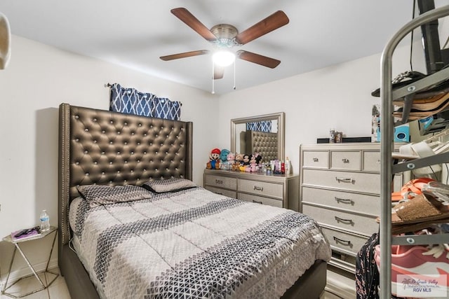 bedroom featuring light tile patterned flooring, a ceiling fan, and baseboards