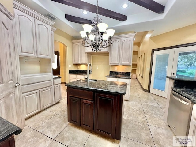27281 Palm Blvd, Harlingen, TX 78552 - kitchen with arched walkways, a chandelier, dishwasher, a raised ceiling, and dark stone countertops