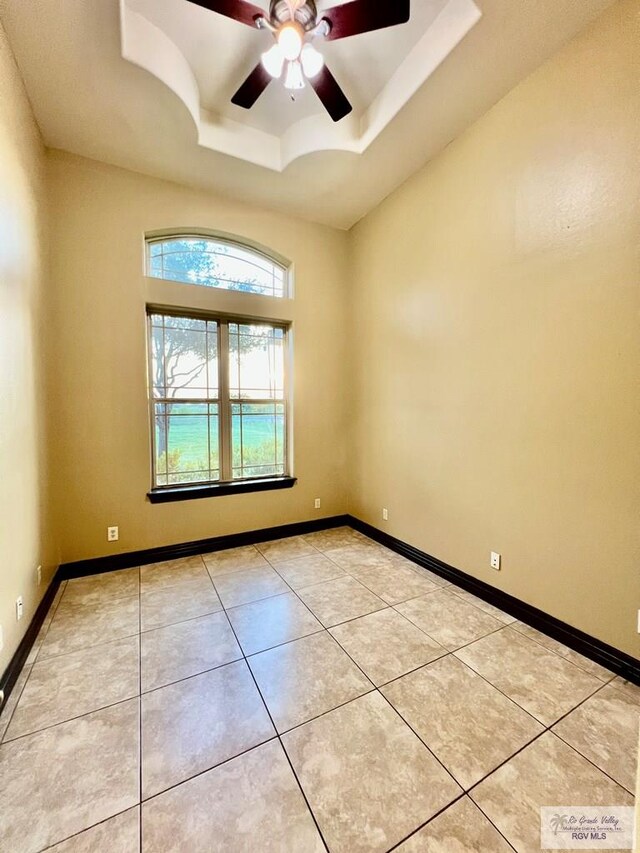 27281 Palm Blvd, Harlingen, TX 78552 - spare room featuring a raised ceiling, a ceiling fan, and light tile patterned floors