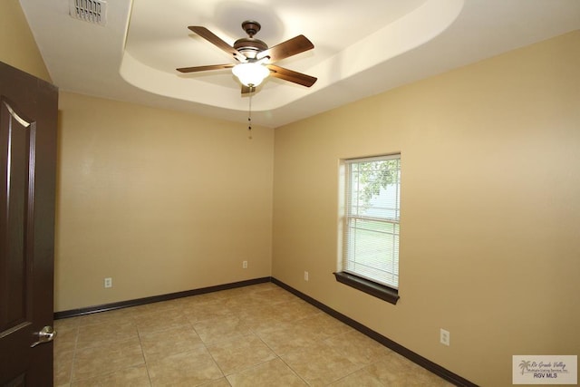 27281 Palm Blvd, Harlingen, TX 78552 - empty room with a ceiling fan, a tray ceiling, and light tile patterned floors