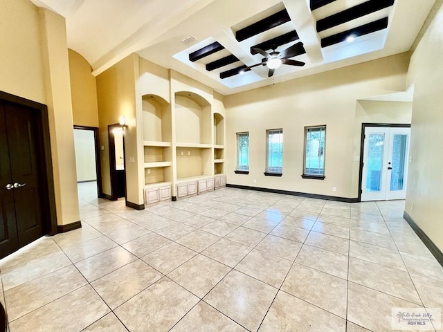 27281 Palm Blvd, Harlingen, TX 78552 - empty room with a towering ceiling, coffered ceiling, light tile patterned floors, built in features, and ceiling fan