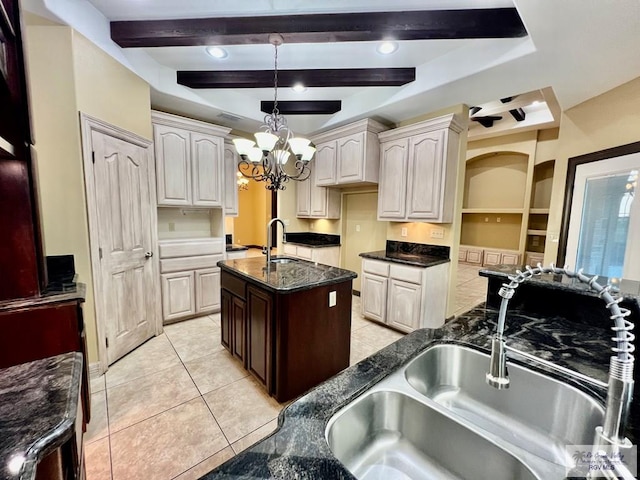 27281 Palm Blvd, Harlingen, TX 78552 - kitchen featuring a chandelier, a kitchen island with sink, pendant lighting, light tile patterned floors, and dark stone counters