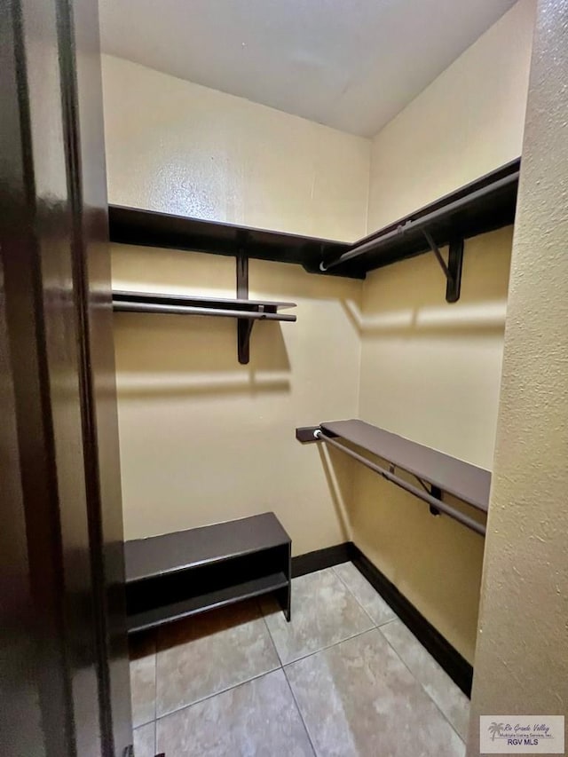 27281 Palm Blvd, Harlingen, TX 78552 - spacious closet featuring light tile patterned floors