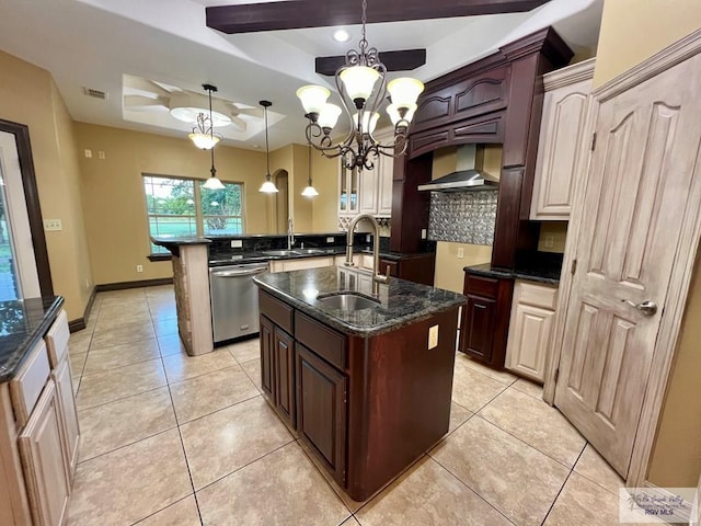 27281 Palm Blvd, Harlingen, TX 78552 - kitchen with stainless steel dishwasher, decorative backsplash, wall chimney range hood, an island with sink, and dark stone counters