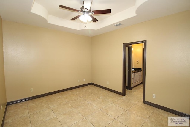 27281 Palm Blvd, Harlingen, TX 78552 - empty room with a ceiling fan, a tray ceiling, and light tile patterned floors