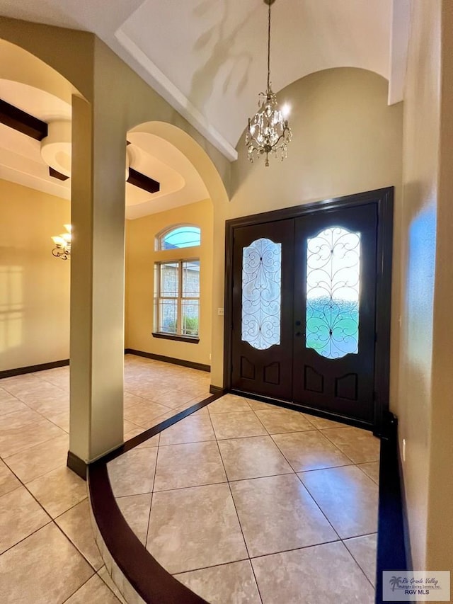 27281 Palm Blvd, Harlingen, TX 78552 - tiled foyer featuring french doors, a chandelier, arched walkways, and high vaulted ceiling
