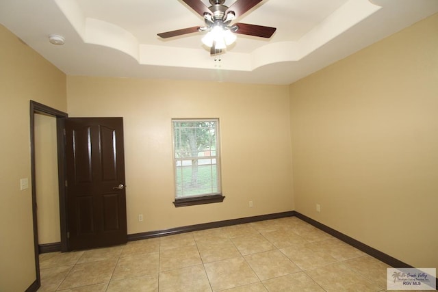 27281 Palm Blvd, Harlingen, TX 78552 - spare room with a raised ceiling, a ceiling fan, light tile patterned floors, and a smoke detector