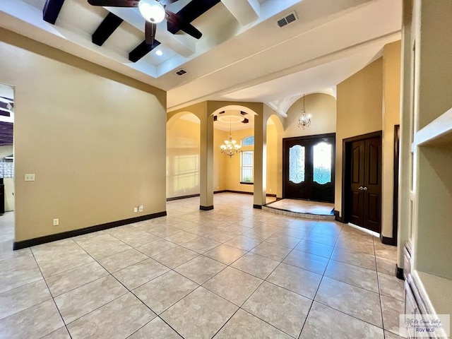 27281 Palm Blvd, Harlingen, TX 78552 - foyer entrance with arched walkways, a chandelier, light tile patterned flooring, ceiling fan, and beamed ceiling