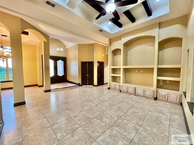 27281 Palm Blvd, Harlingen, TX 78552 - unfurnished living room with arched walkways, built in features, a chandelier, and light tile patterned flooring