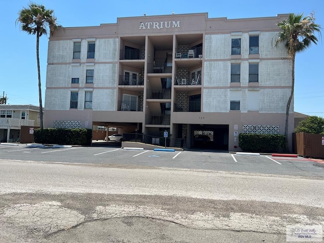 109 W Tarpon St Unit 301, South Padre Island, TX 78597 - view of apartment building / complex featuring uncovered parking
