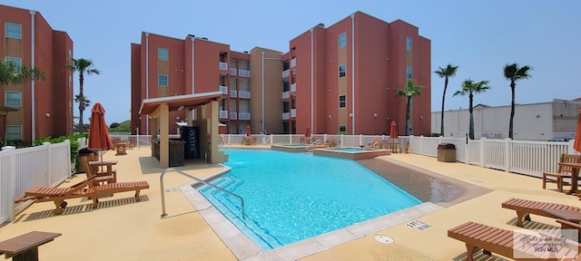 view of pool featuring a community hot tub and a patio area