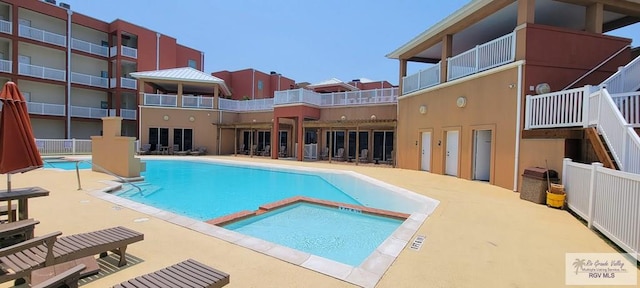 view of pool with a community hot tub and a patio