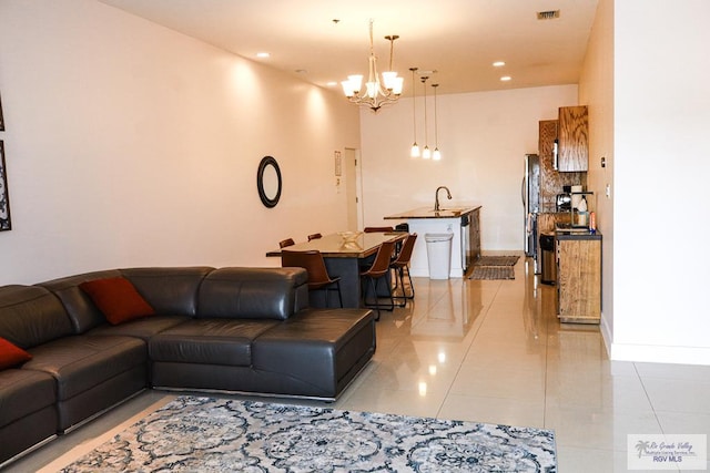 tiled living room featuring a chandelier