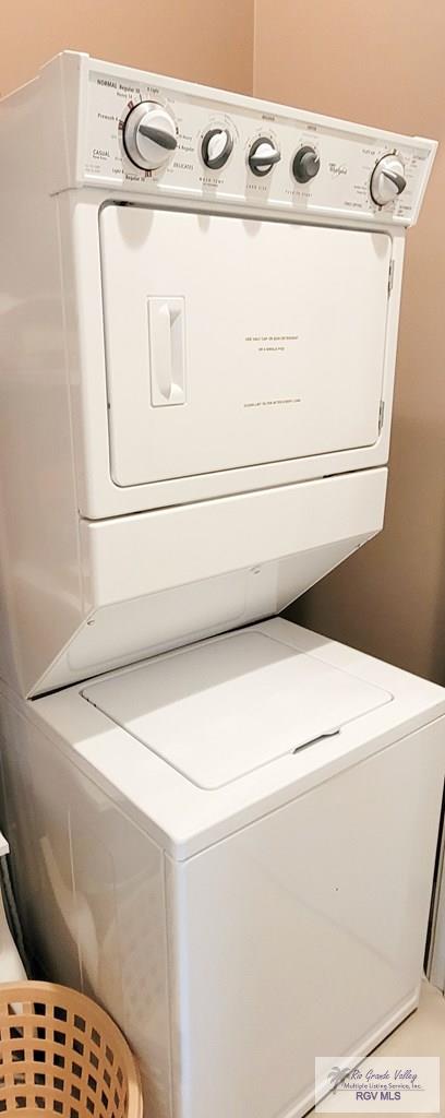 laundry area with stacked washer and clothes dryer