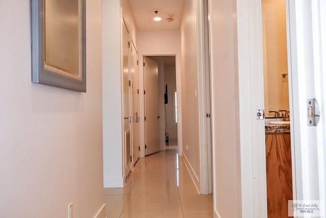 hall featuring light tile patterned flooring