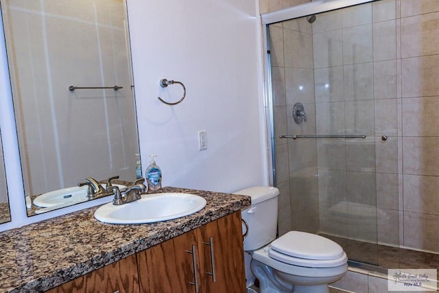 bathroom with walk in shower, vanity, and toilet