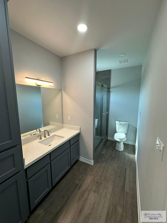 2299 Athens St, Brownsville, TX 78520 - bathroom with vanity, a shower stall, and wood finished floors