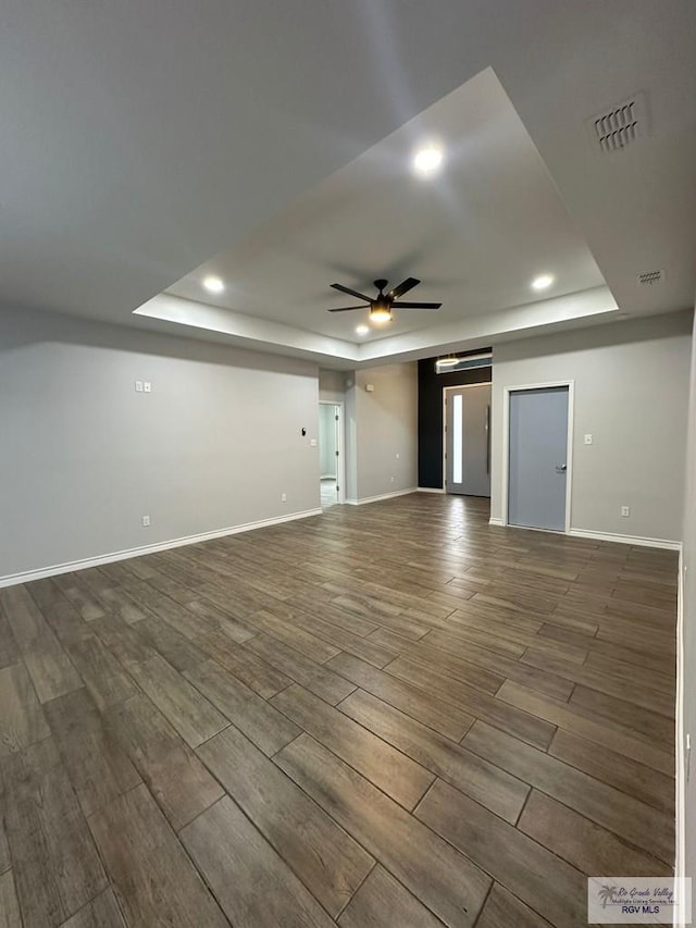2299 Athens St, Brownsville, TX 78520 - unfurnished living room featuring a tray ceiling, ceiling fan, wood finished floors, and recessed lighting
