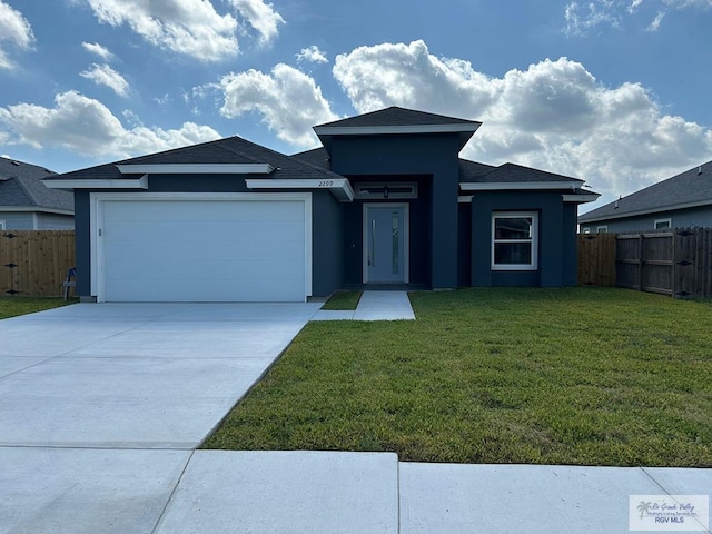 2299 Athens St, Brownsville, TX 78520 - view of front facade with a garage, stucco siding, and driveway
