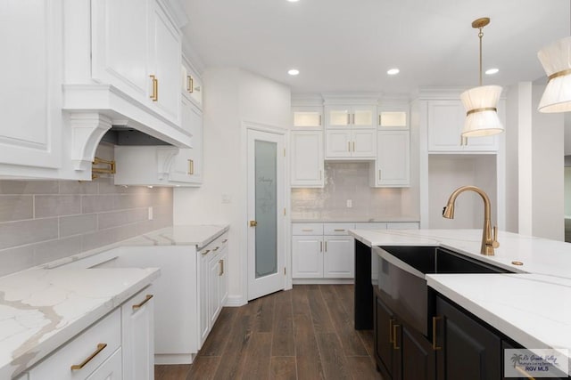 kitchen with white cabinets, decorative light fixtures, and dark wood-type flooring