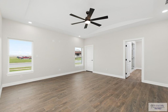 unfurnished room featuring ceiling fan and dark hardwood / wood-style floors