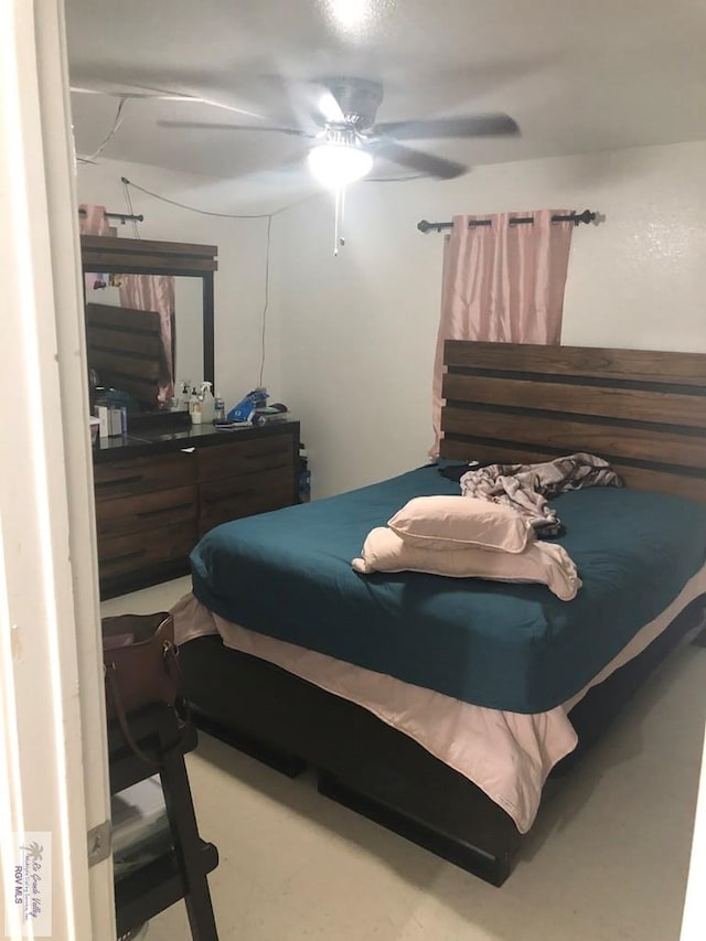 bedroom featuring ceiling fan and concrete flooring