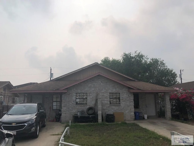 ranch-style home with a front yard and central AC unit