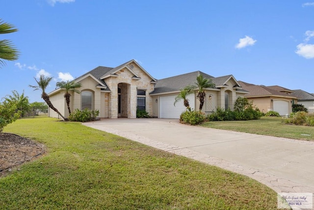 view of front of property featuring a garage and a front lawn