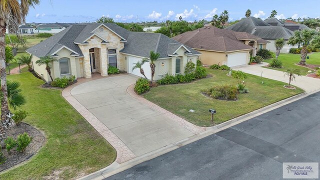 view of front of house with a front yard and a garage