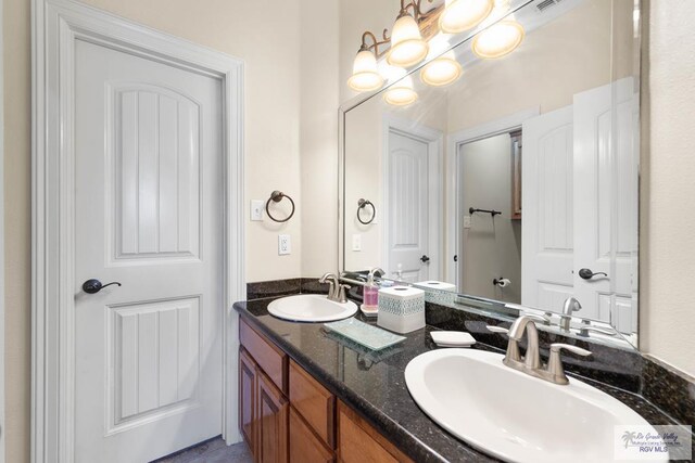 bathroom with vanity and an inviting chandelier