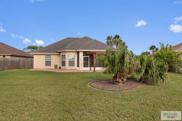 back of property with a lawn and a patio area