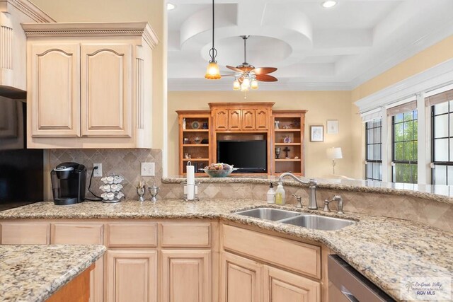 kitchen featuring light brown cabinets, sink, hanging light fixtures, stainless steel dishwasher, and decorative backsplash