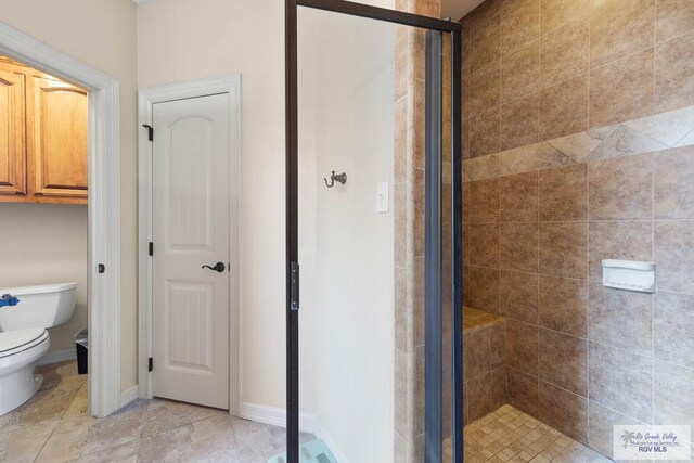 bathroom featuring toilet and walk in shower