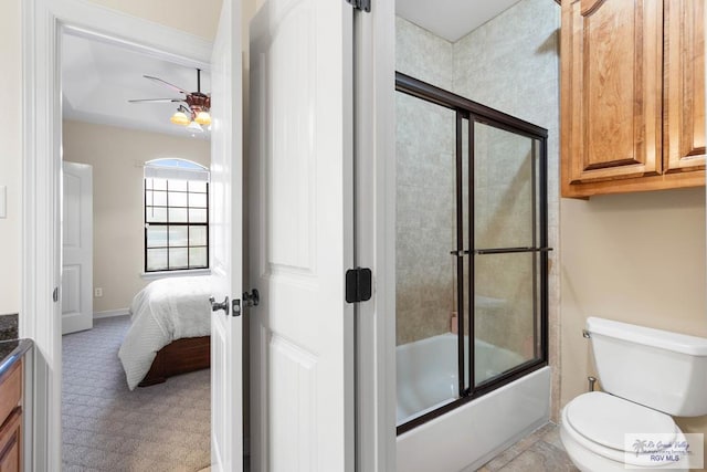 full bathroom featuring ceiling fan, toilet, combined bath / shower with glass door, and vanity