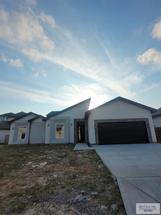 ranch-style home featuring a garage