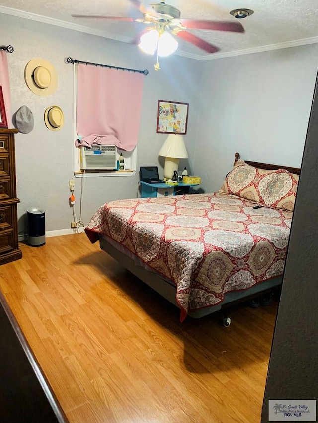 bedroom featuring wood-type flooring, ceiling fan, and ornamental molding