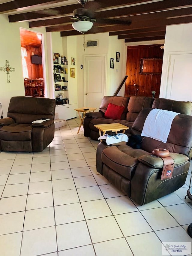 tiled living room featuring ceiling fan and beamed ceiling