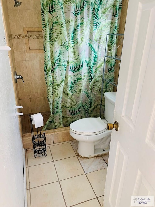 bathroom featuring a shower with shower curtain, tile patterned floors, and toilet